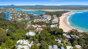 An aerial view of a coastal resort with beachfront properties, a marina, and a beach. - Stunning Duplex with Rooftop Terrace (Little Cove)