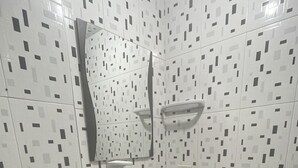A small bathroom with a toilet, sink, and mirror. - HOSTEL PARA VIAJEROS (Bogotá)