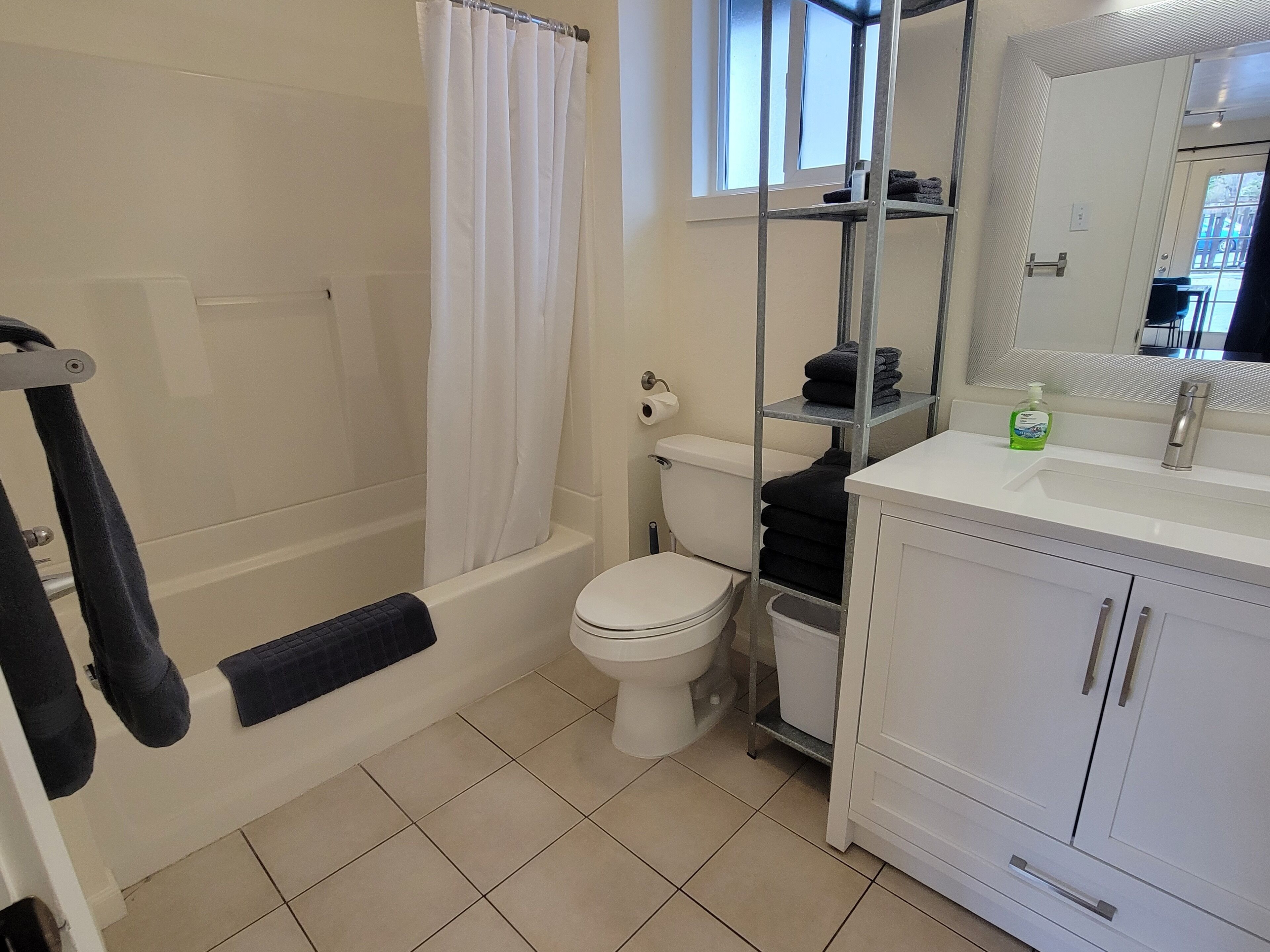 A bathroom with a bathtub, toilet, and sink.