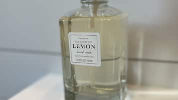A bottle of coconut lemon hand wash on a white surface.