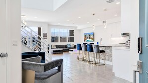 A modern hotel lobby with a staircase, seating area, and a kitchen/lounge area. - Lakefront with privet Pool 4 master  (Indio)