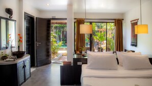 A hotel room with a bed, bedside tables, a desk, a mirror, and a view of the garden. - Bunwin Siem Reap (Siem Reap)