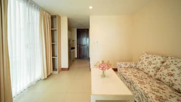 Deluxe kamer | Woonruimte | Een 40-inch flatscreentelevisie met digitale zenders en een televisie