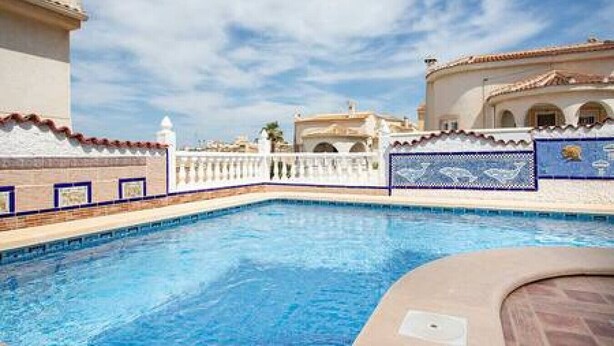 A swimming pool with a white fence and a tiled deck. - CH Villa Africa La Marquesa Golf (Ciudad Quesada) (Ciudad Quesada)