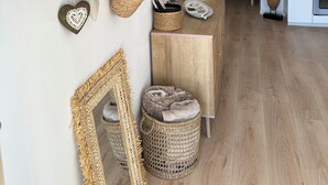 A modern kitchen with wooden cabinets, a hanging light fixture, and a small dining area with a bench. - Quiet studio with terrace (Rougemont)