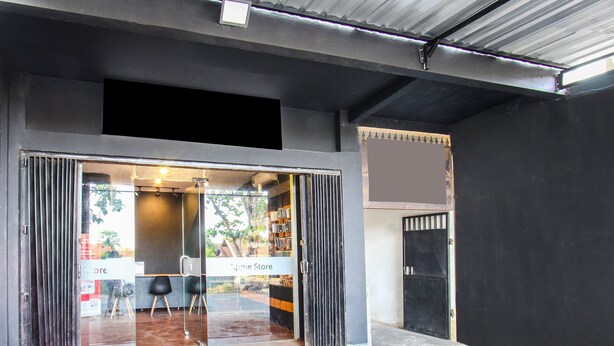 A storefront with a glass door and a sign reading "Apple Store." - OYO 91391 Mutiara Syariah 3  (Mataram)