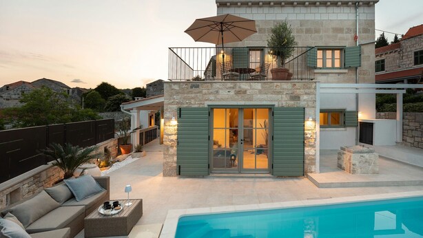 A two-story house with a pool, stone walls, and outdoor seating. - Villa Mara Casa Rustica ZadarVillas (Korcula)