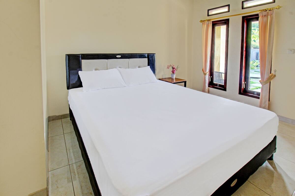 Laptop workspace, bed sheets