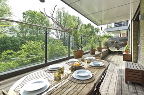 Enjoy meals with a view of lush greenery from the dining area's large windows.