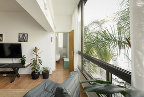 Apartment | Living area | 50-inch LCD TV with cable channels, TV - Stylish 2-Bedroom Green Oasis (Tel Aviv)