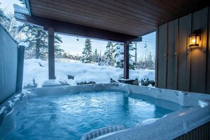 A hot tub with a wooden deck and a view of a snowy landscape. - Location, Location, Location! Ski in Ski out at Trapper's Landing #23 (Sun Peaks)