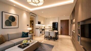 A modern living room with a sofa, coffee table, and artwork.