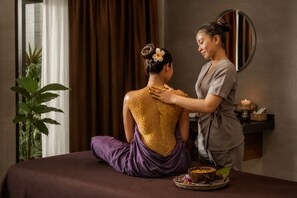 A person receiving a massage on a bed in a room with a plant and a mirror. - Soladia Hotel & Residences by One Park (Phnom Penh)