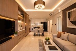 A modern living room with a sofa, a coffee table, and a TV.