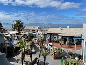 Experience the charm of a Mediterranean coastal town with stunning sea and mountain views, shops, and eateries.