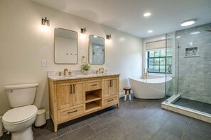 Bathtub, hair dryer, towels, toilet paper