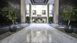 A spacious lobby with a marble floor, large columns, and potted plants. - Mabaat - Al Malqa - 523 (Riyadh)