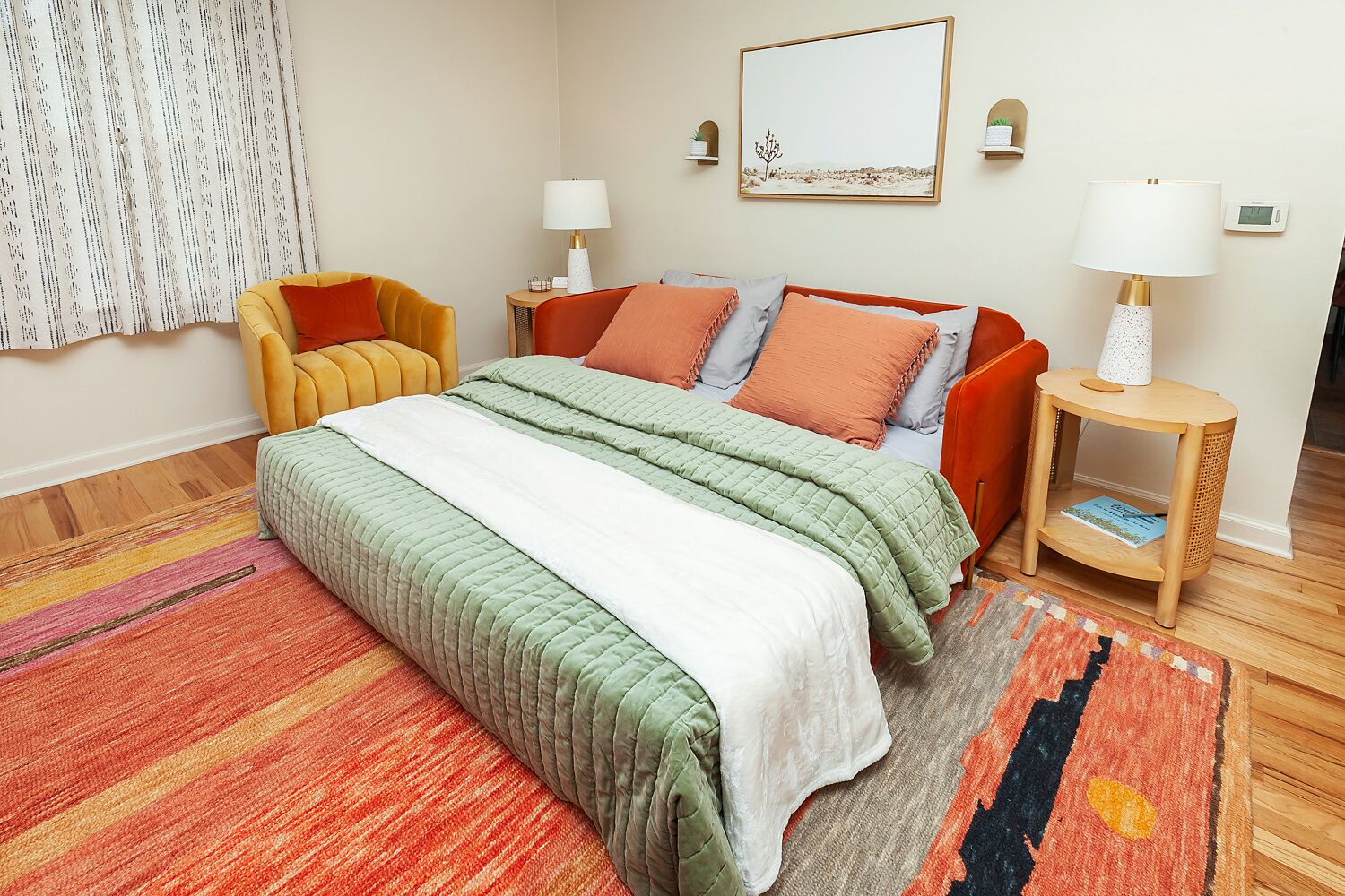 A modern bedroom with a bed, two bedside tables, a chair, and a large window with curtains.