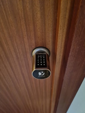 A door with a keypad lock and a logo.