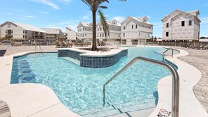 A swimming pool with a palm tree, surrounded by buildings with a uniform architectural style.