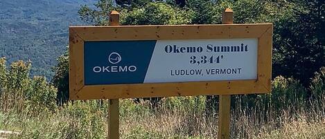 A sign indicating Okemo Summit at 3,344 feet in Ludlow, Vermont.