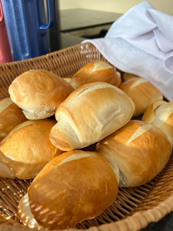 A basket of freshly baked bread rolls.