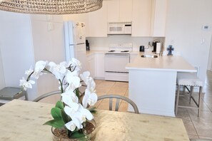 Enjoy cooking in this kitchen with a central island, sink, oven, and stainless steel appliances.