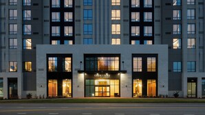 A modern hotel with a prominent 'Courtyard by Marriott' sign, large windows, and a well-lit entrance. - Courtyard by Marriott Gainesville GA (Gainesville)
