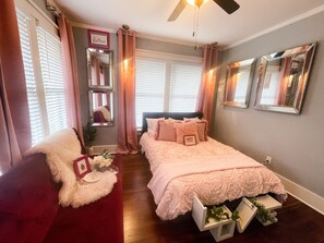 A bedroom with a bed, a chair, a ceiling fan, and a window with blinds. - Beautiful spacious home near midtown, downtown and popular attractions. (Memphis)