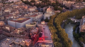 An aerial view of a cityscape with historic architecture, a river, and a prominent dome structure.