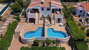 A large villa with a swimming pool, a covered patio, and a well-maintained garden. - V110B | Villa La Pau (Son Bou)