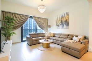 Exclusive Apartment | Living area | 55-inch Smart TV with cable channels, TV - HiGuests - Act Tower 1 (Dubai)