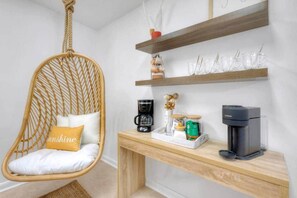 A room with a hanging chair, a coffee station, and shelves with glassware. - Surf Shack! Pool table! Fire Pit! 10 min to beach! (Martin County)