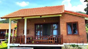 Guests can relax on the covered porch with a large planter and enjoy the tranquil surroundings.