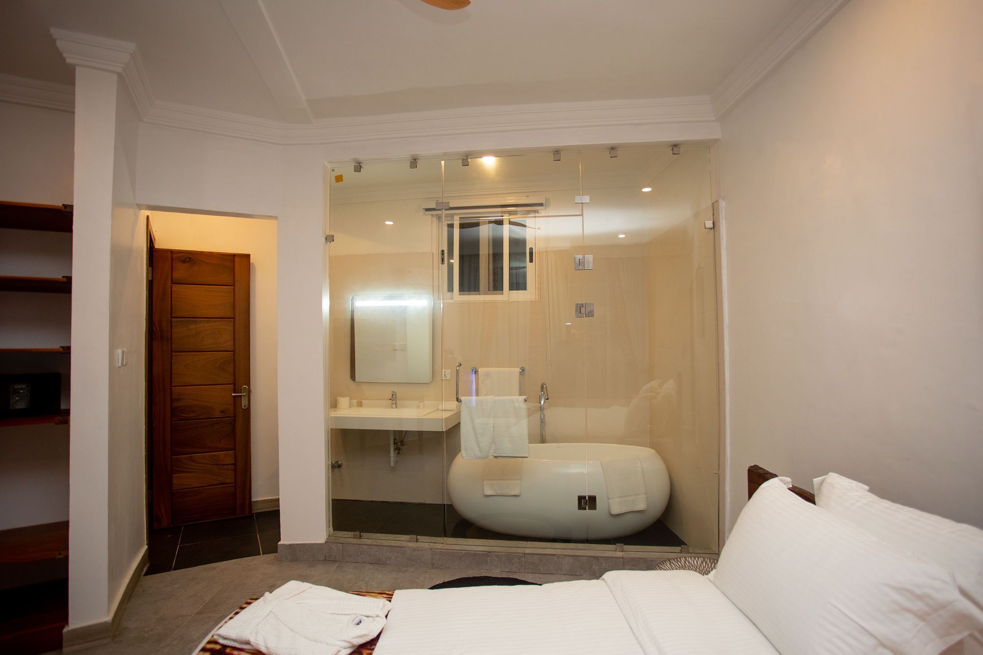 A modern bathroom with a glass-enclosed shower, a toilet, and a sink.