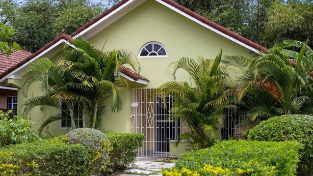 A single-story house with a red roof and a small front porch. - Bamboo Villa  (St. Ann's Bay)