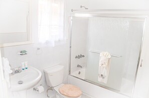 A bathroom with a toilet, sink, and shower. - Bamboo Villa  (St. Ann's Bay)