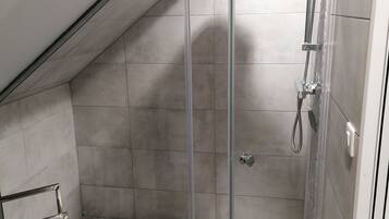 Shower, hair dryer, soap, toilet paper