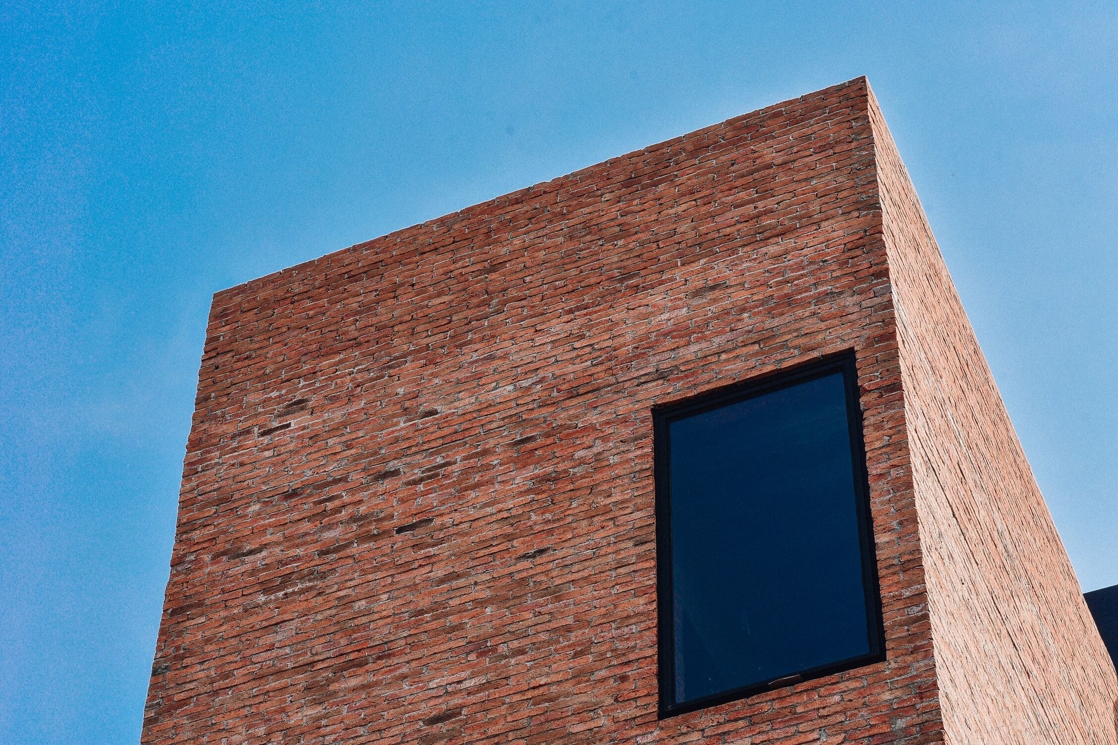 A building with a brick facade and a large window.