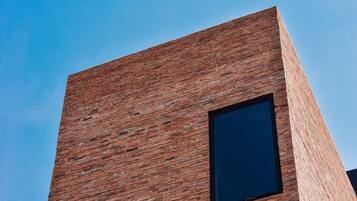 A building with a brick facade and a large window.