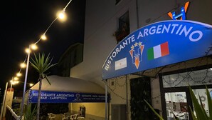 A restaurant named 'Ristorante Argentino' with outdoor seating and string lights. - Hotel Valente (Ortona)