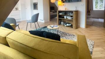 Deluxe Apartment, Balcony, Partial Sea View (Un balcon sur la mer) | Living area | 120-inch LED TV with digital channels, TV