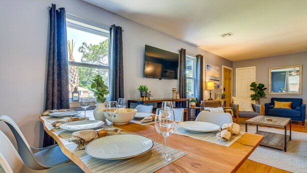 A dining area with a wooden table set for four, surrounded by chairs. - Pet-Friendly Pensacola Home w/ Sunny Backyard! (Pensacola)