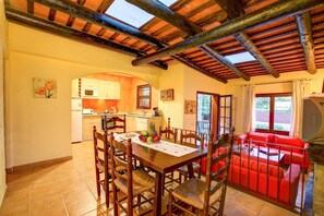 Enjoy meals in this well-appointed dining area with a table for four, surrounded by comfortable chairs.