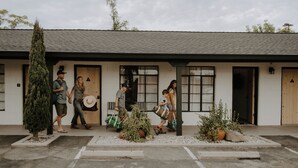 A building with a simple facade, large windows, and a door. - Triangle Motel (Red Bluff)
