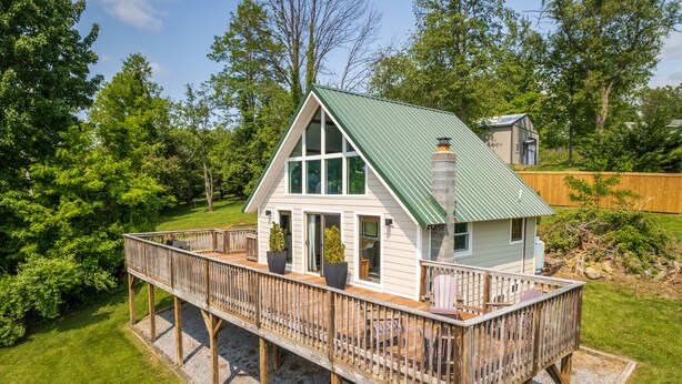 A house with a deck, large windows, and a chimney. - Overlook Loft - Scenic Shenandoah Views (Elkton)