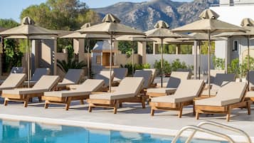 Seasonal outdoor pool, open 10:00 AM to 8:00 PM, pool umbrellas