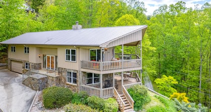 View-worthy home lined by trees with a fireplace, wrap-around deck, grill, & W/D