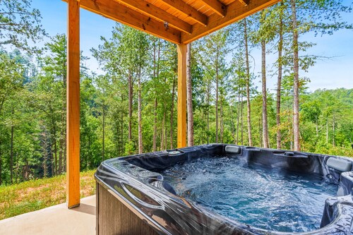 Calming river view Georgia home with fireplace, firepit, balcony, & hot tub