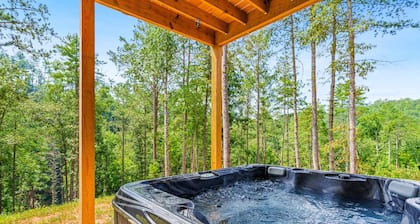 Calming river view Georgia home with fireplace, firepit, balcony, & hot tub